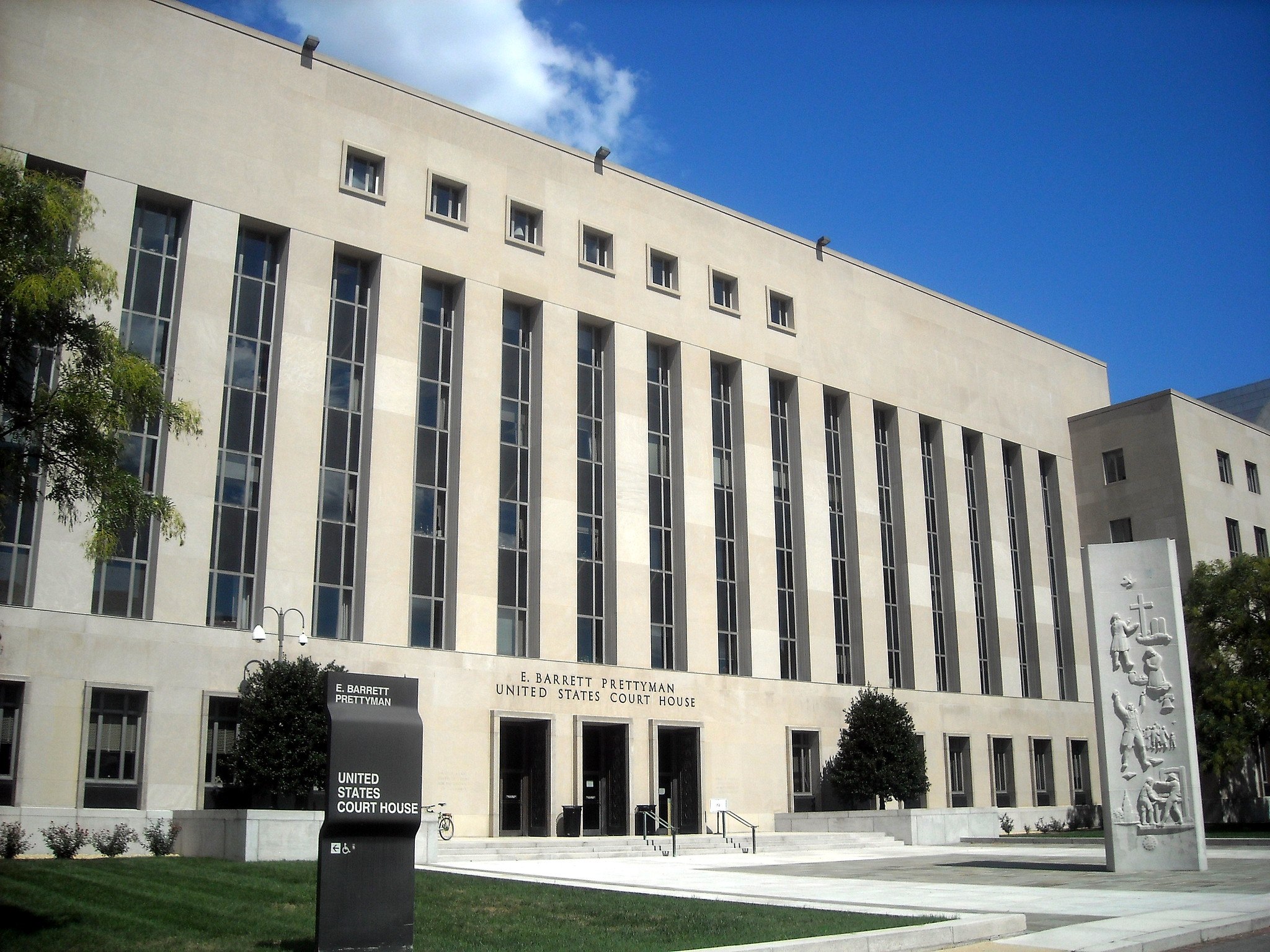 The exterior of a United States District Court building, with the courthouse name visible on the facade