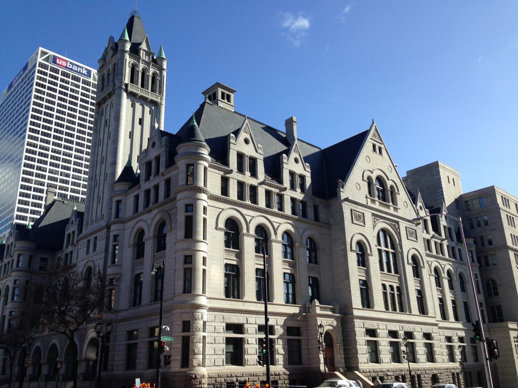 The exterior of a federal courthouse in Milwaukee, Wisconsin, photographed from street level with the building facade and signage visible