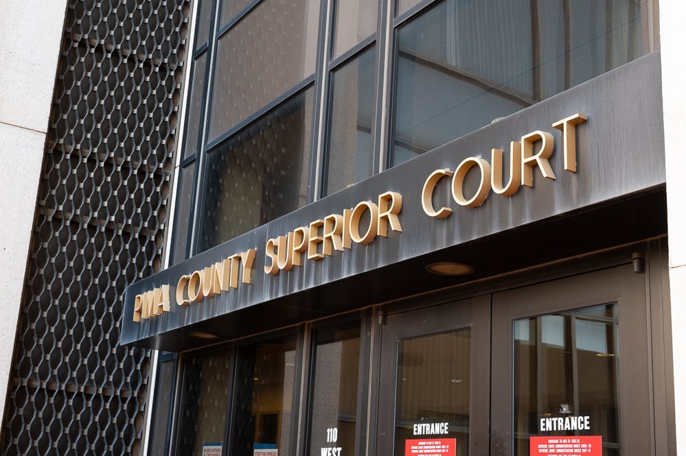 The exterior of the Pima County Superior Court building in Tucson, Arizona, photographed in daylight with people walking near the entrance