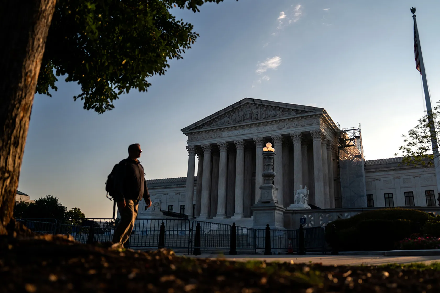 The exterior of the Supreme Court of the United States in Washington, DC on a clear day with the marble steps and columns visible, news photography style