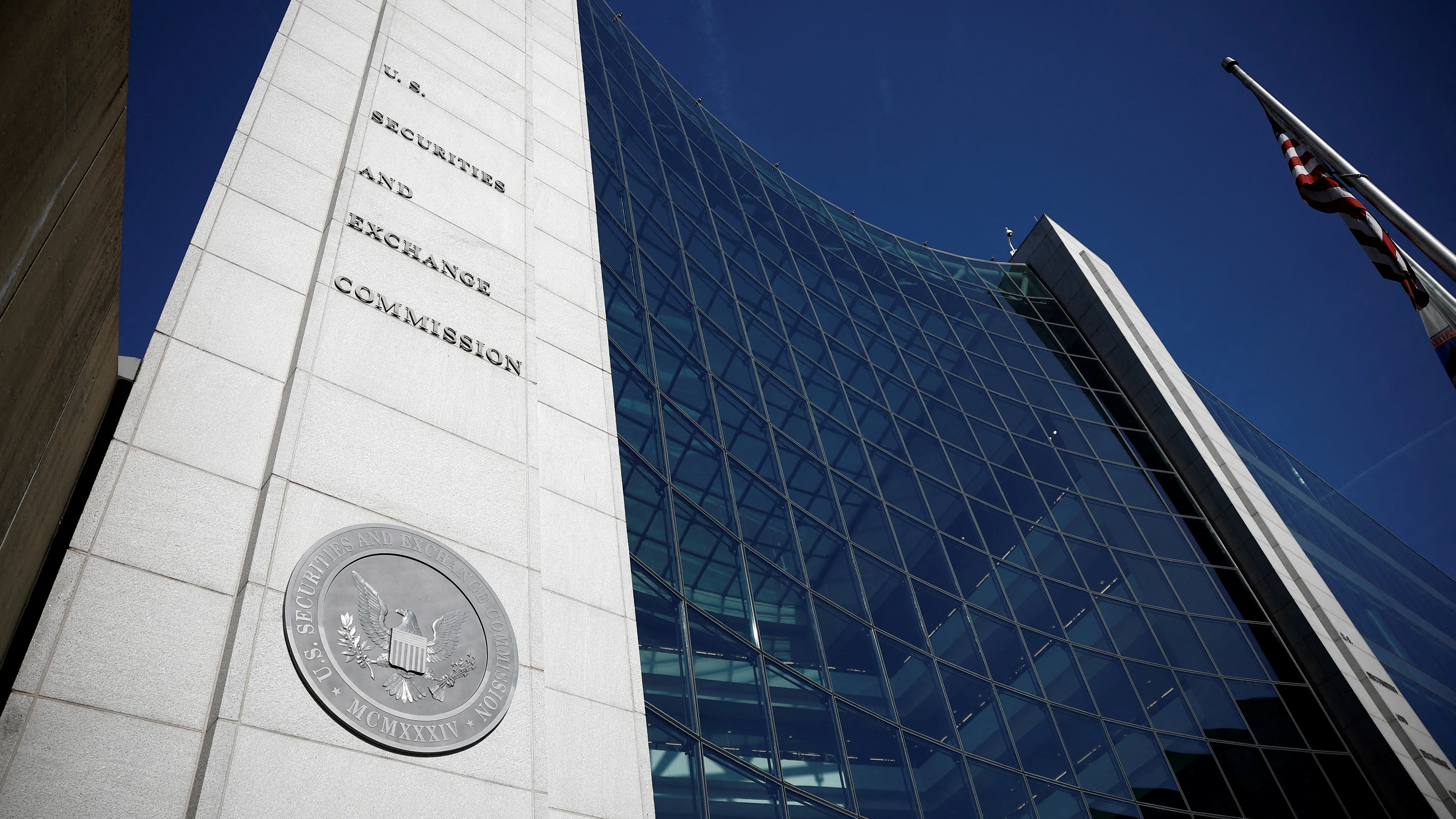 The exterior of the U.S. Securities and Exchange Commission headquarters in Washington, D.C., with pedestrians walking past the building, news photography style