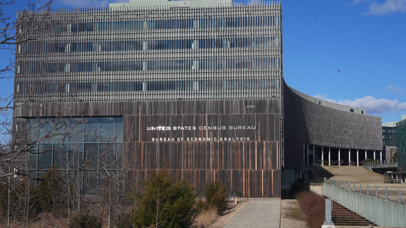 The exterior of the United States Census Bureau headquarters building on a clear day, photographed from street level with the entrance visible