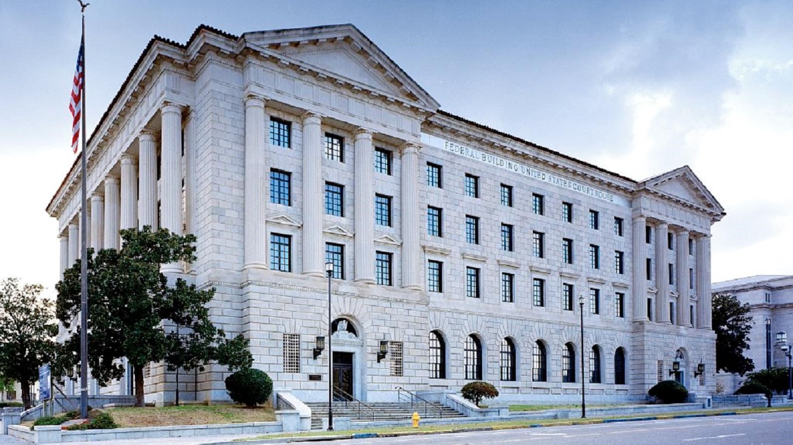 The exterior of the United States District Court for the Middle District of Alabama, showing the courthouse facade and main entrance