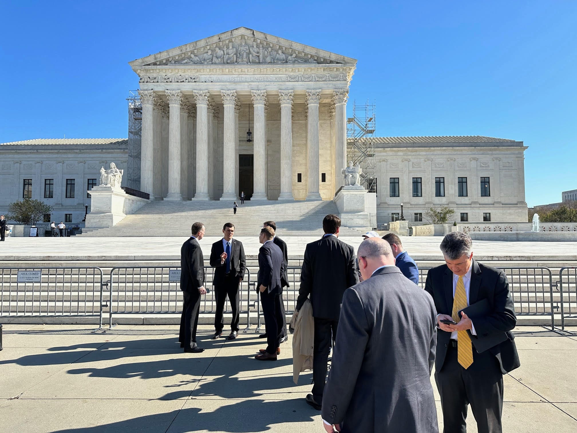 The exterior of the United States Supreme Court building on a clear day, straight-on news photography style