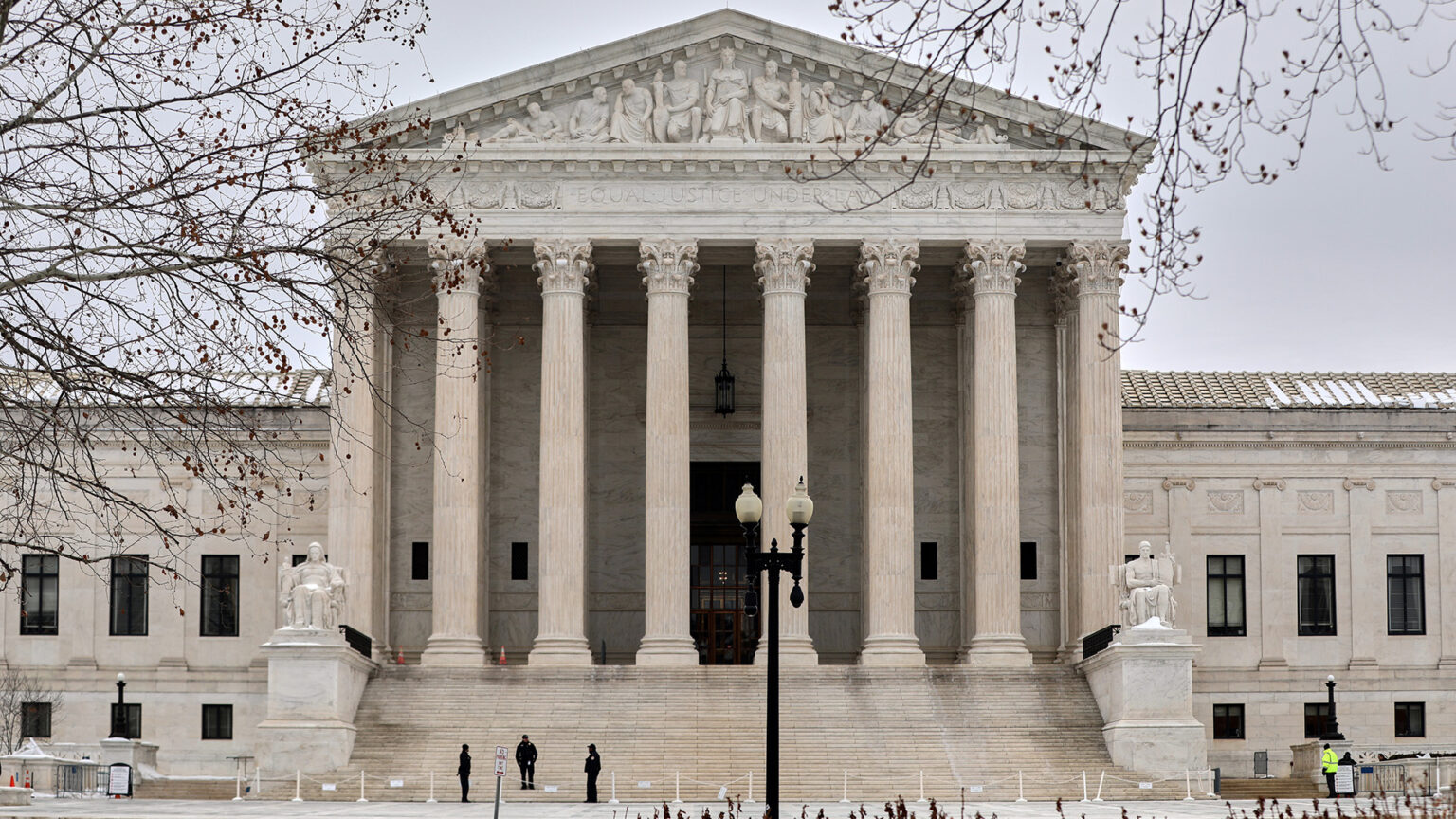 The exterior of the United States Supreme Court building with its columns and broad front steps on a clear day, news photography style