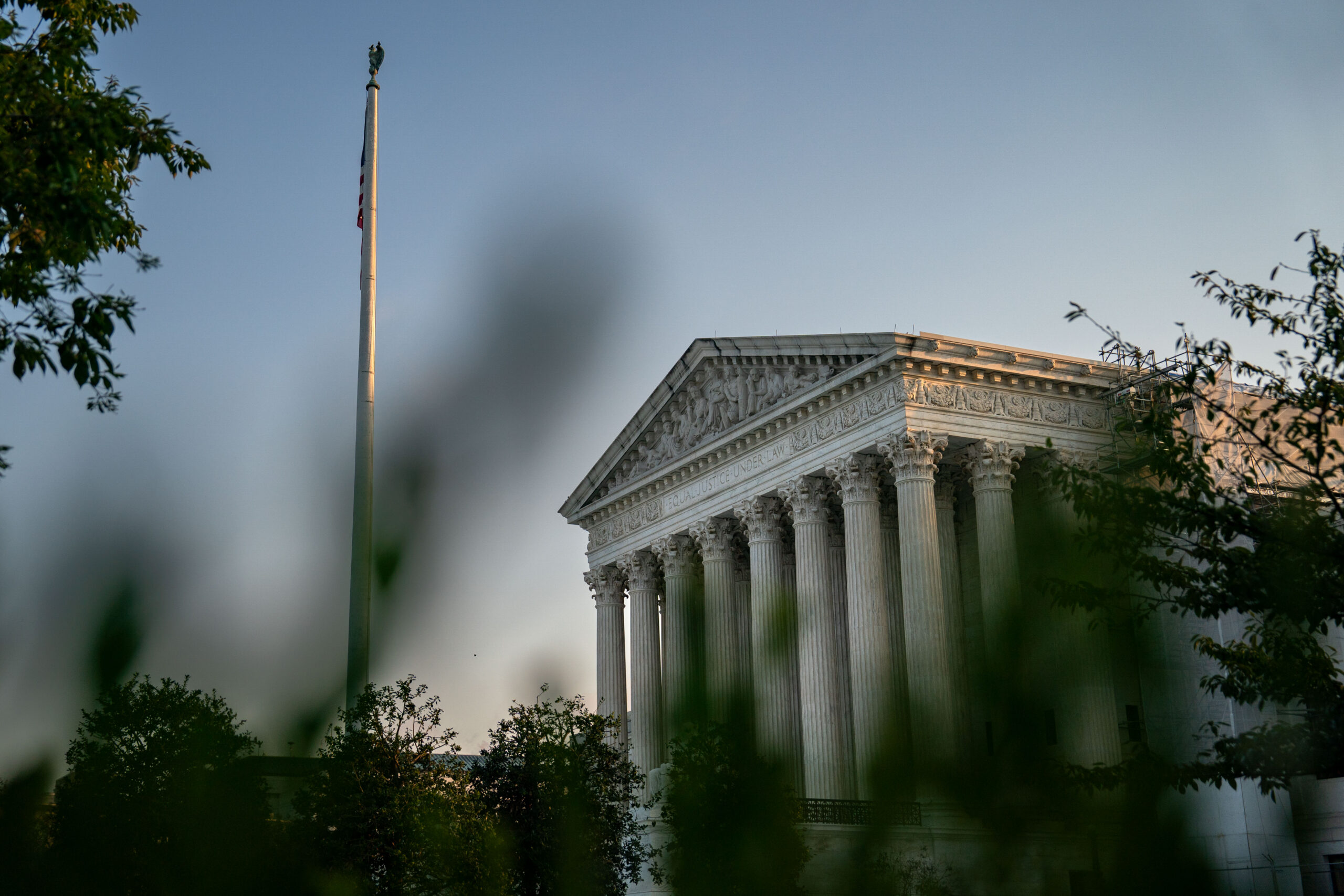 The exterior of the United States Supreme Court building in Washington, DC, photographed from ground level on a clear day, editorial news photography style