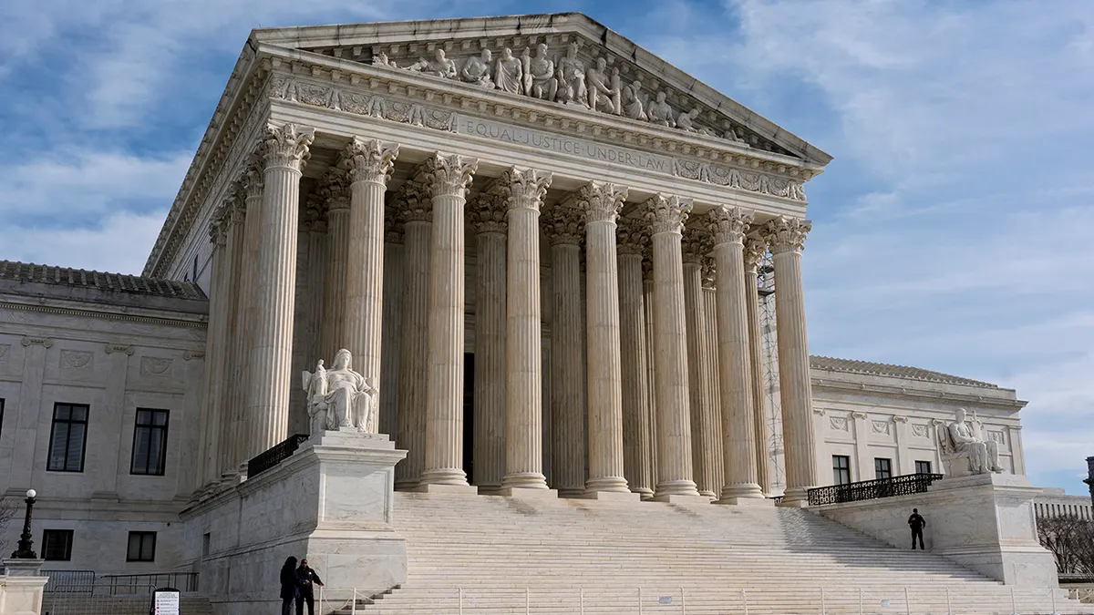 The exterior of the United States Supreme Court building in Washington, DC, photographed from the plaza in daylight, realistic editorial photo