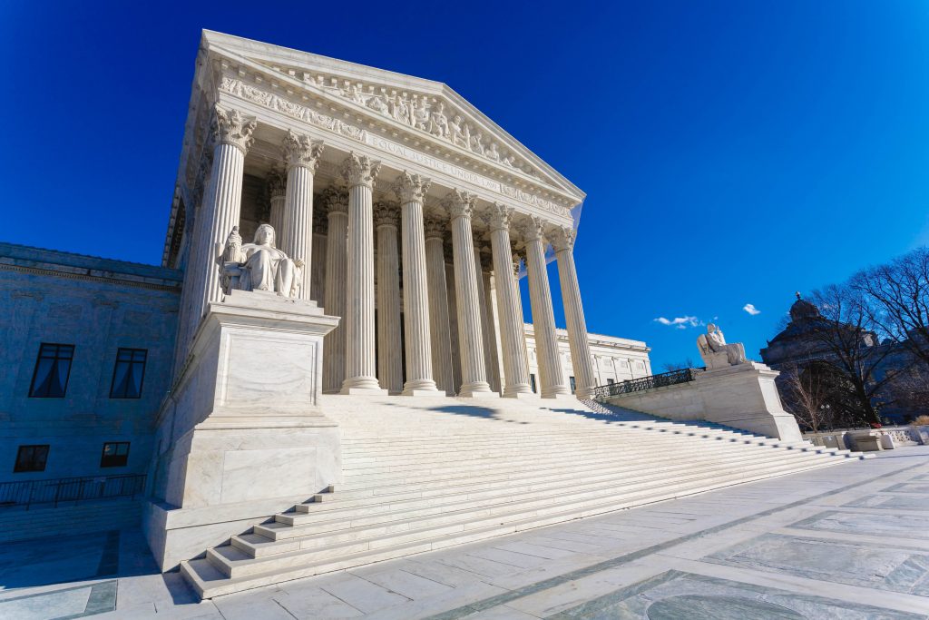 The exterior of the United States Supreme Court building in Washington, D.C., with the marble steps and columns visible in daylight