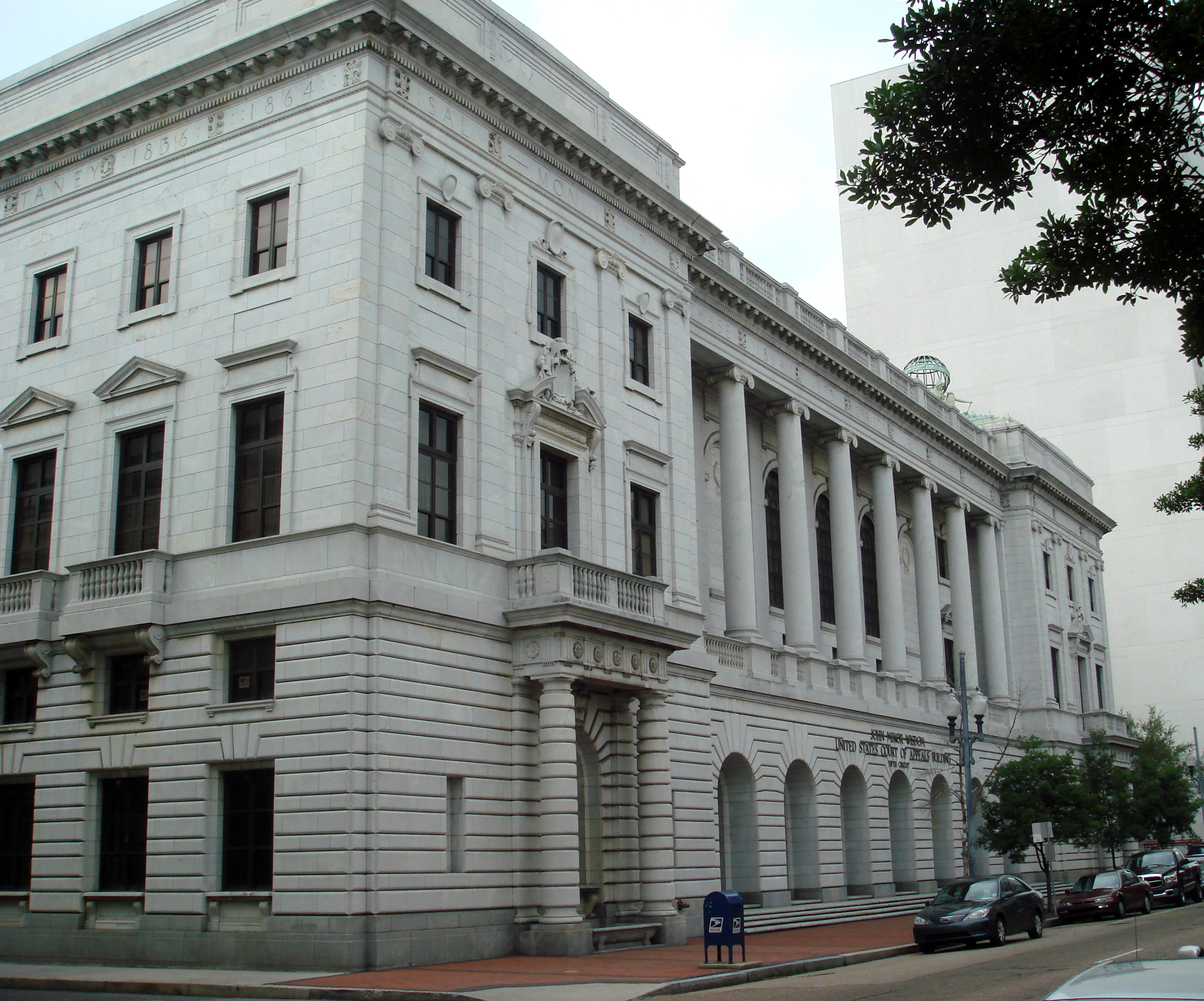 The exterior of the federal courthouse associated with the Fifth Circuit in New Orleans on a clear day, realistic news photography style