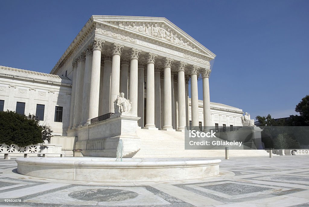 The front steps of the United States Supreme Court building in Washington, D.C., with its columns and broad staircase in daylight, news photography style