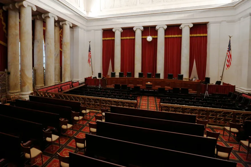 The interior of the U.S. Supreme Court courtroom with the bench and seating visible, photographed from the public gallery