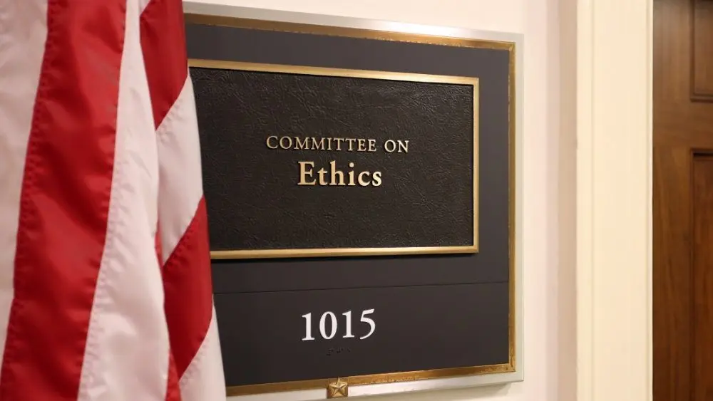 The official seal of the U.S. House Committee on Ethics displayed at a public briefing or in a committee setting
