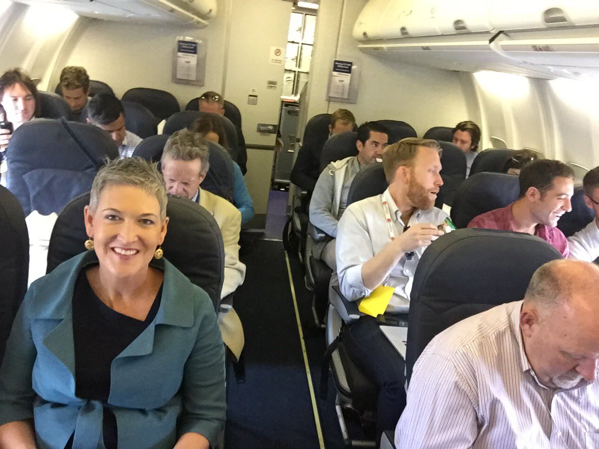 The press seating area aboard Air Force One, showing tightly arranged seats and equipment used by traveling reporters