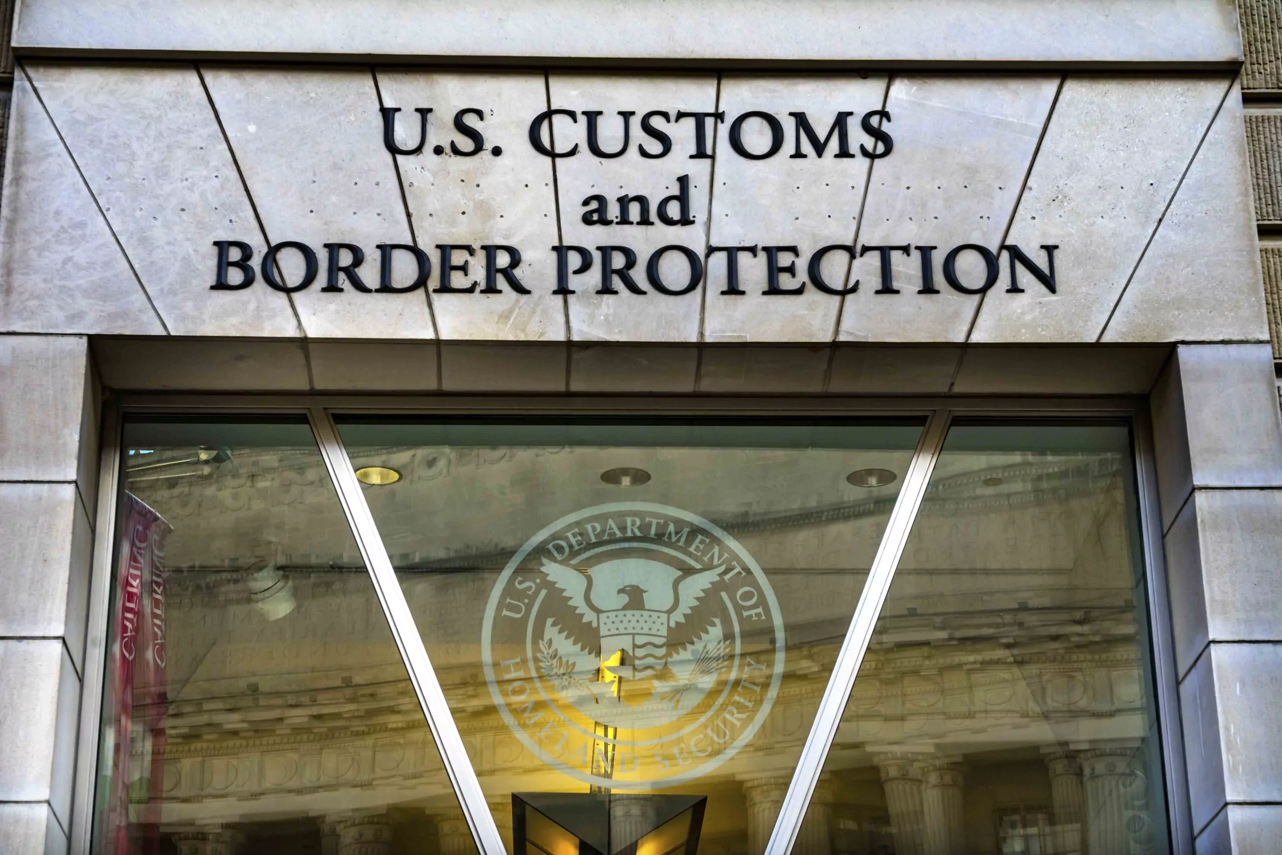 The seal of U.S. Customs and Border Protection displayed on a sign at a federal facility