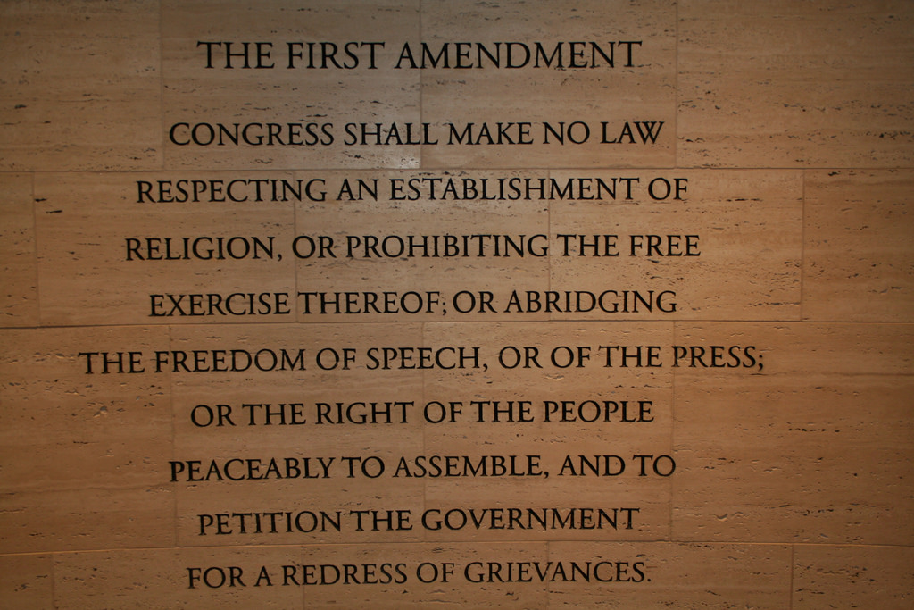The text of the First Amendment on a display of the U.S. Constitution