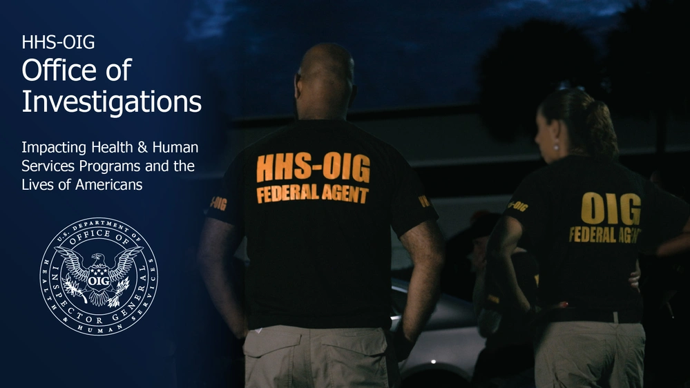 Two federal investigators in business attire reviewing paper case files at a conference table inside a government office, documentary news photography style
