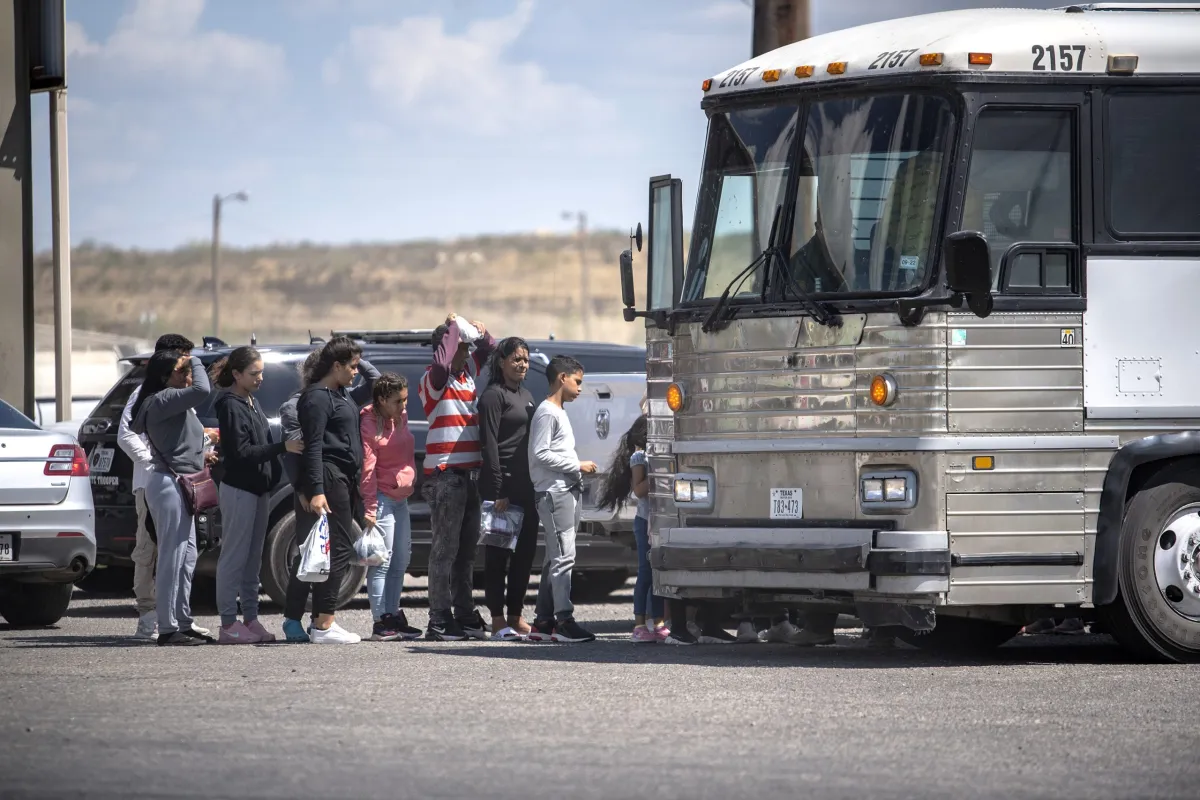 U.S. Border Patrol agents conducting an enforcement operation near the Rio Grande at the U.S.-Mexico border in daylight, with marked vehicles and agents in uniform visible