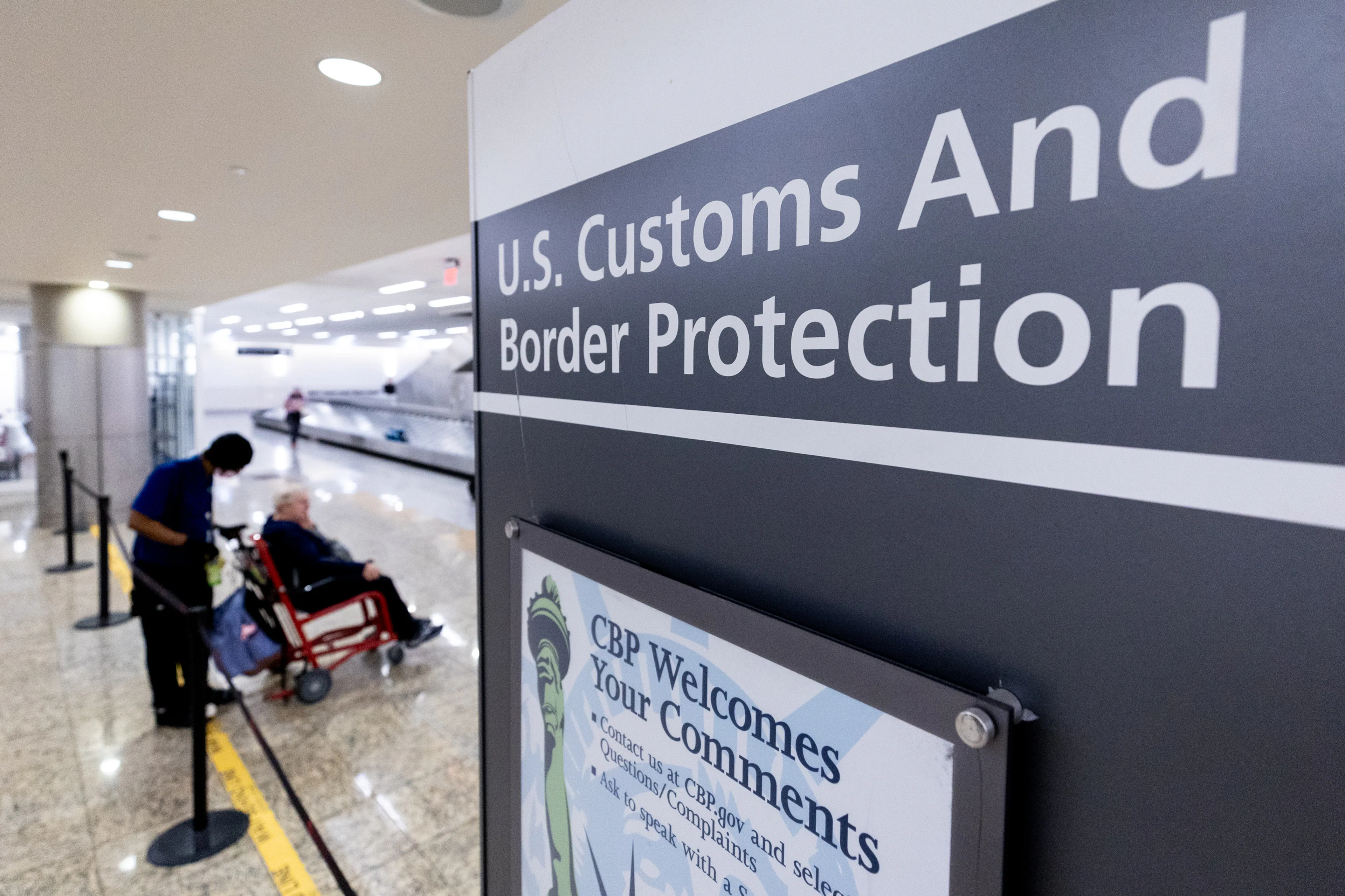 U.S. Customs and Border Protection officers and travelers in an international arrivals area at Hartsfield-Jackson Atlanta International Airport