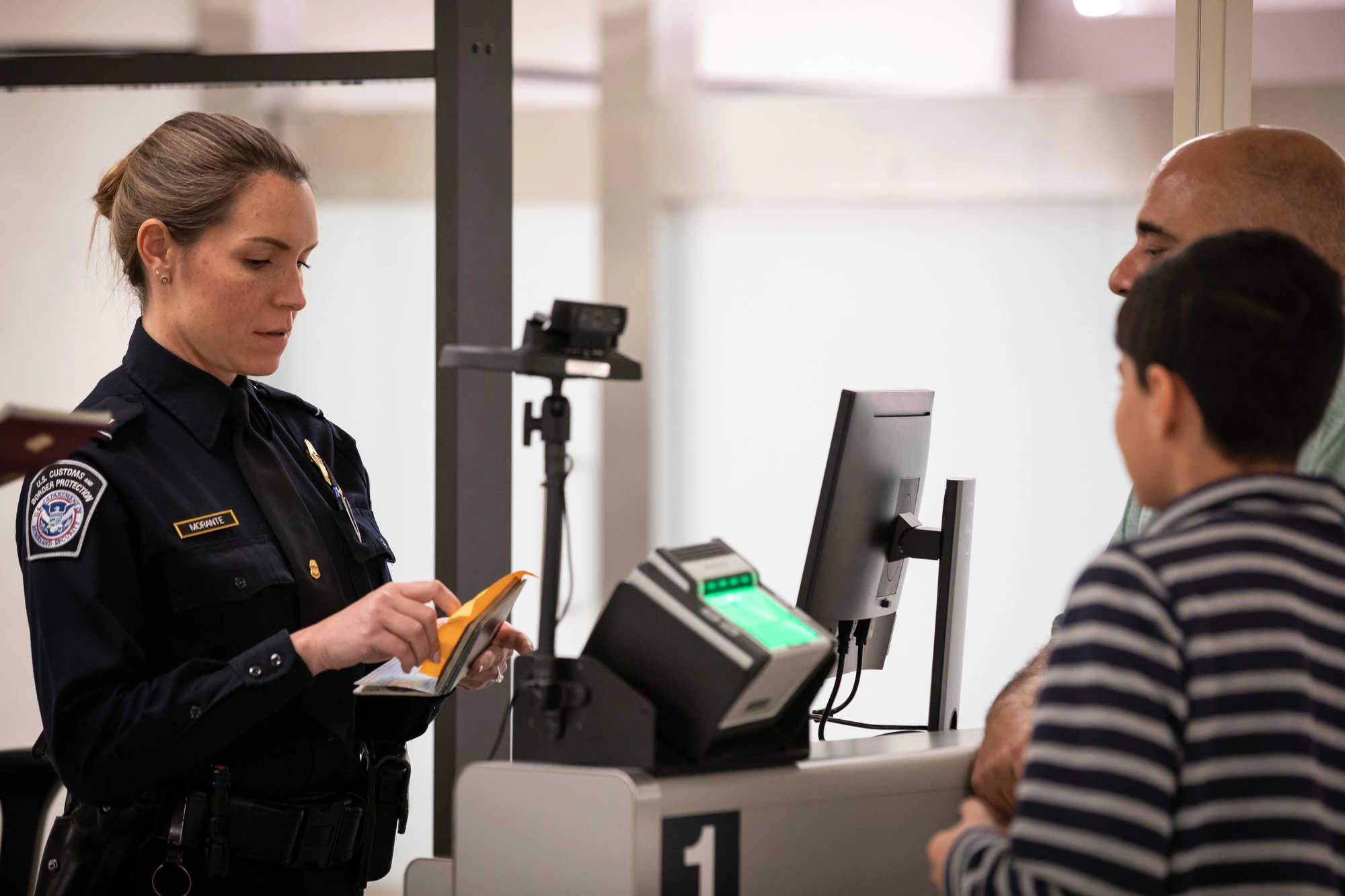 U.S. Customs and Border Protection officers working in an international arrivals area at John F. Kennedy International Airport in New York.