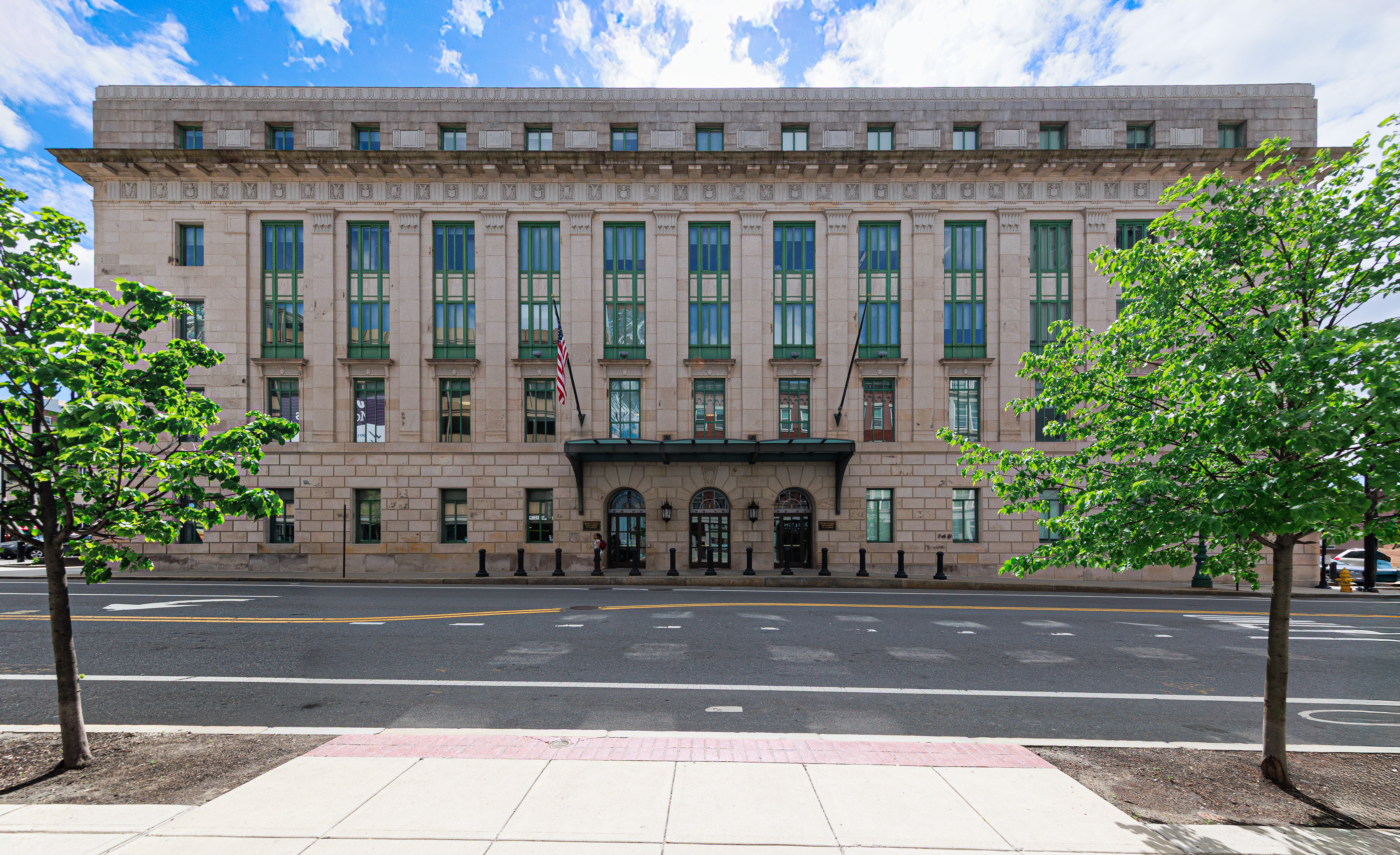 U.S. District Judge Brian Murphy outside a federal courthouse in Massachusetts, speaking with court staff or attorneys after a hearing