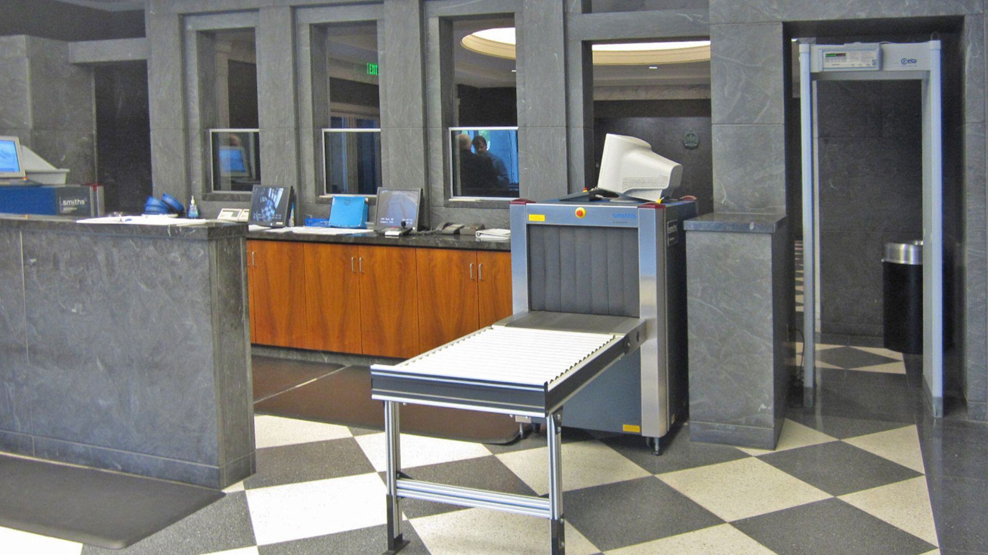 U.S. Marshals Service personnel and court security screening at a federal courthouse entrance.