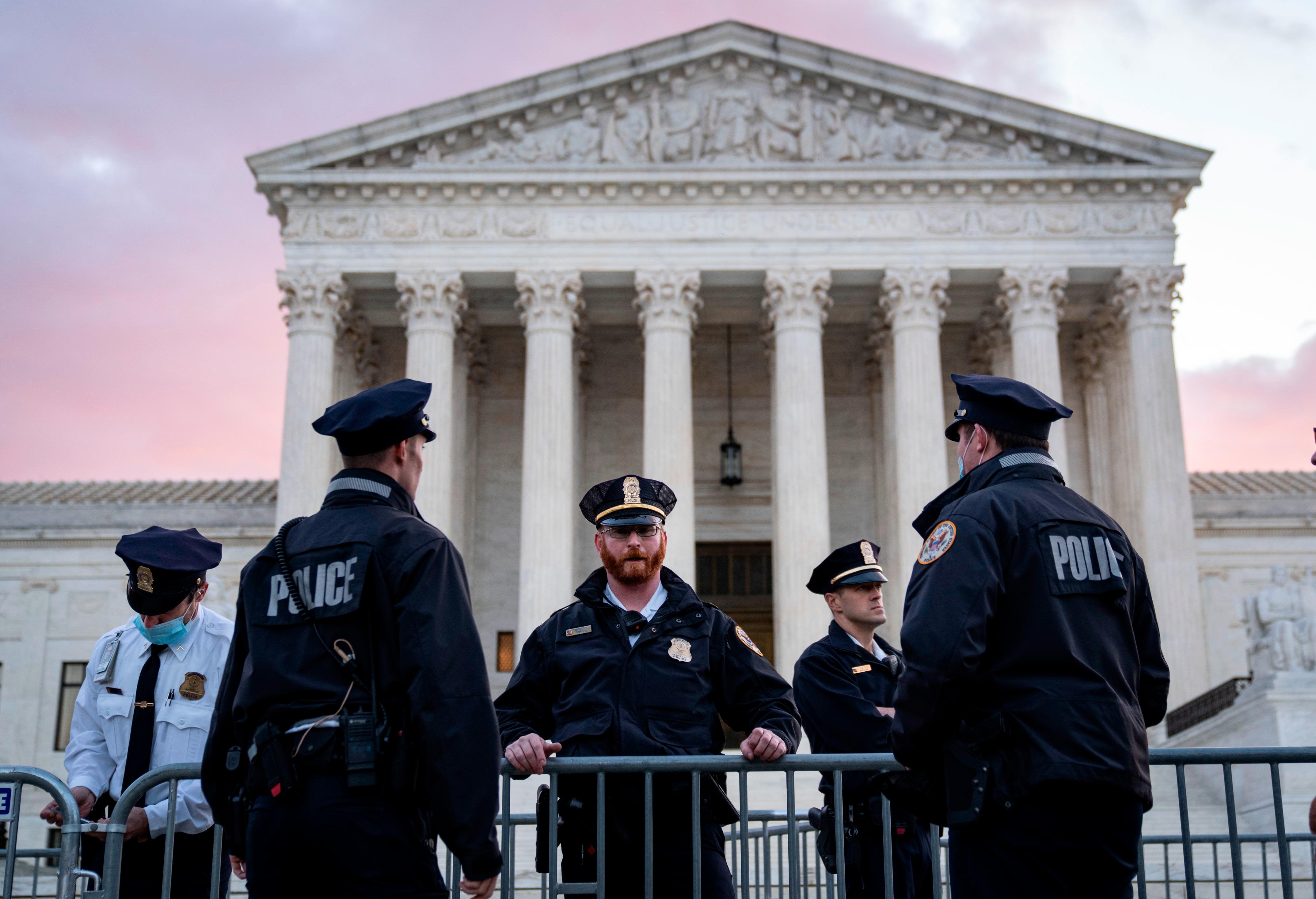 U.S. Supreme Court Police officers standing outside the Supreme Court building near the plaza