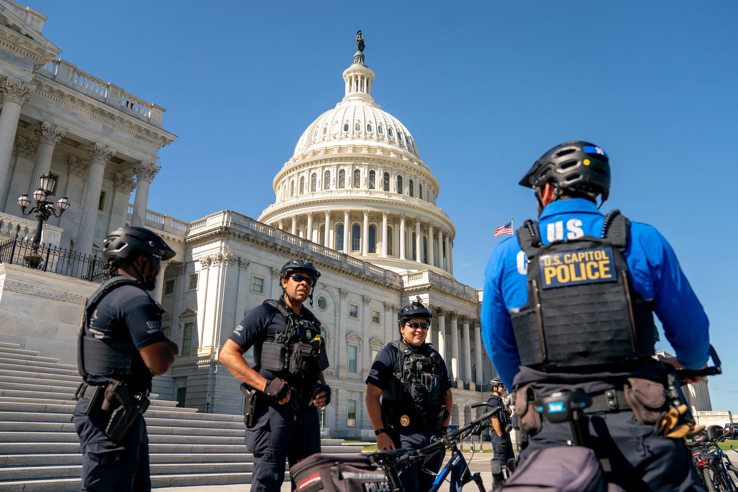 Uniformed U.S. Capitol Police officers standing on the Capitol grounds in Washington, D.C., during a public day