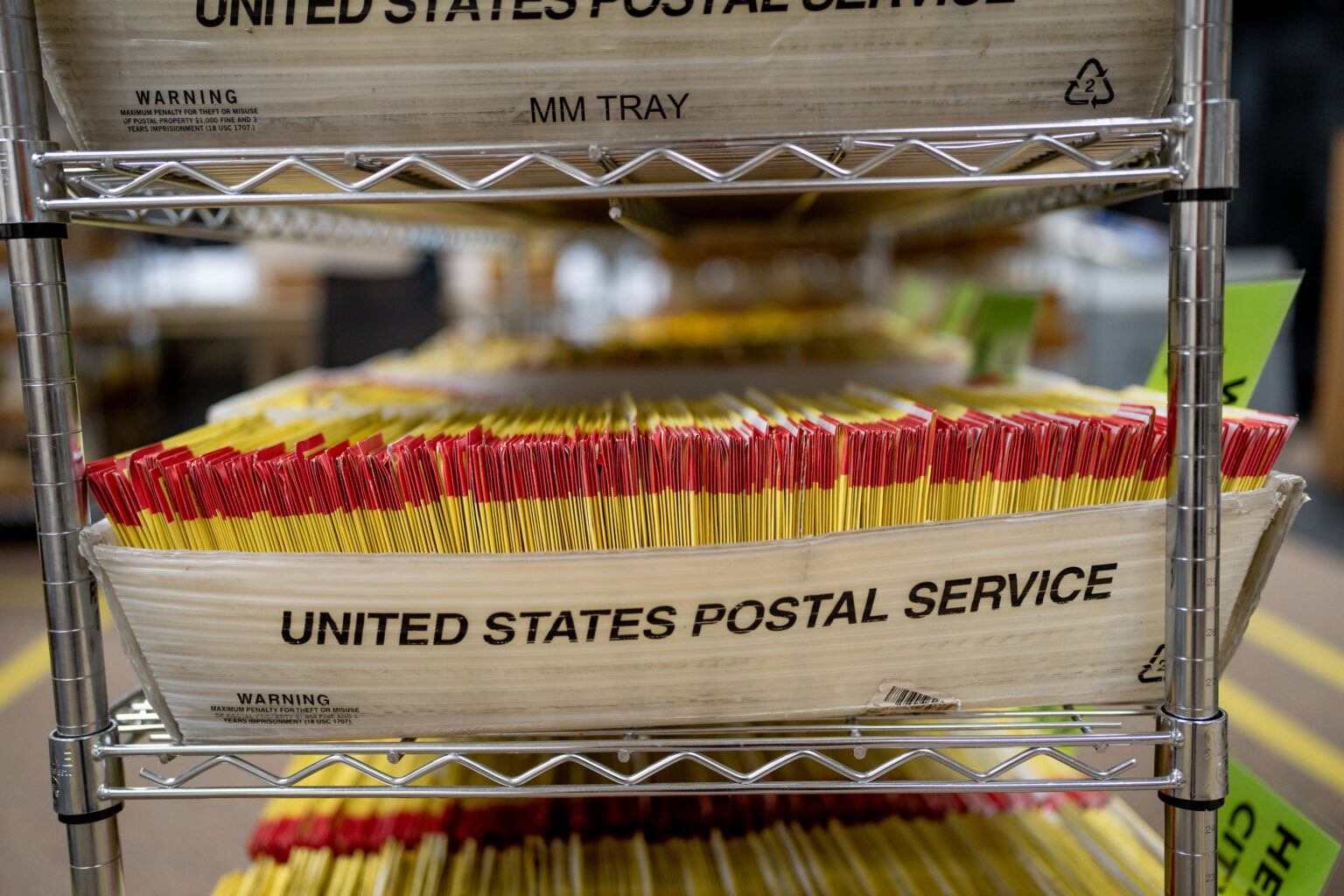United States Postal Service trays and signage associated with handling Election Mail at a postal facility