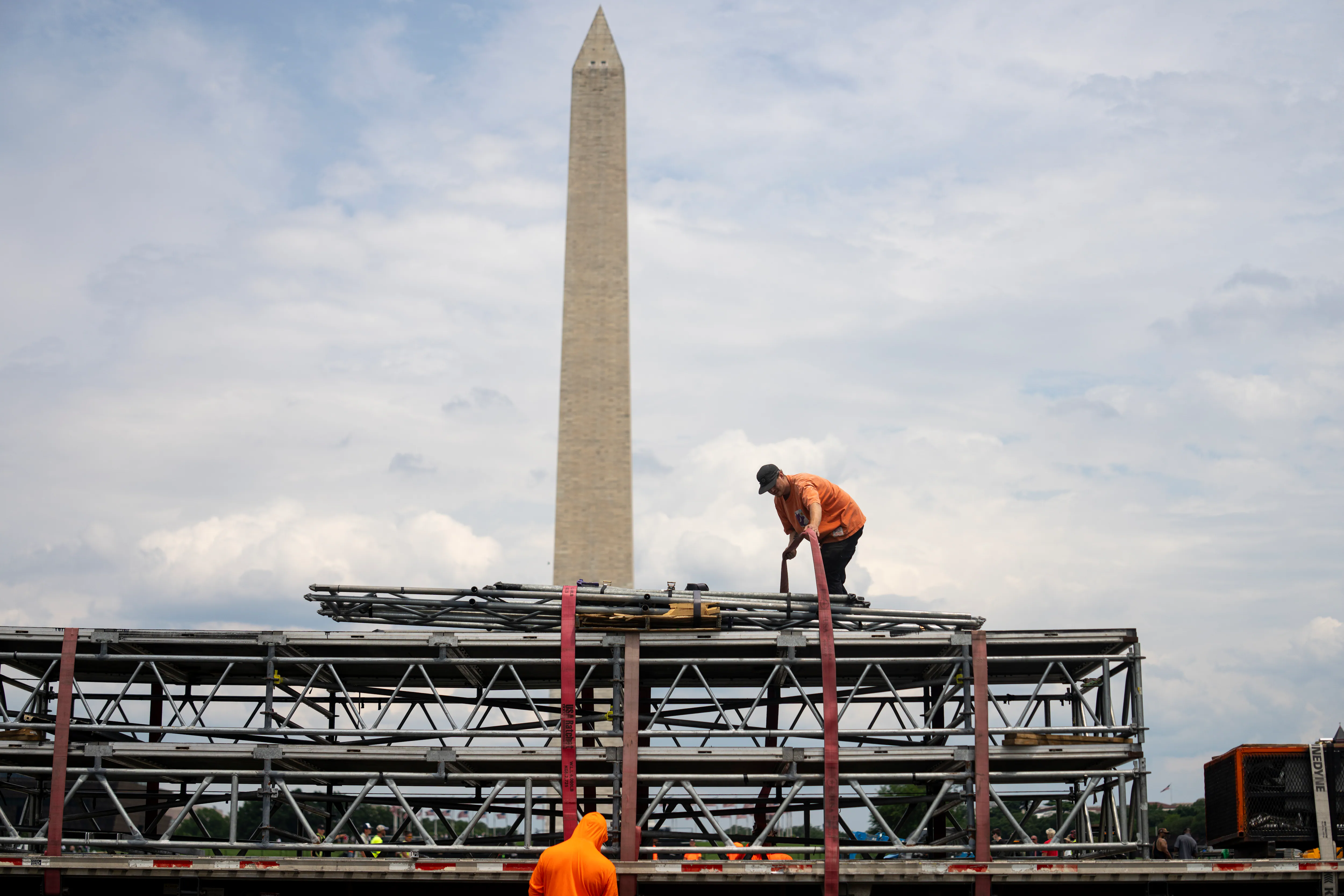 Visitors walking along a pedestrian path on the National Mall near the Smithsonian Castle in Washington, D.C.