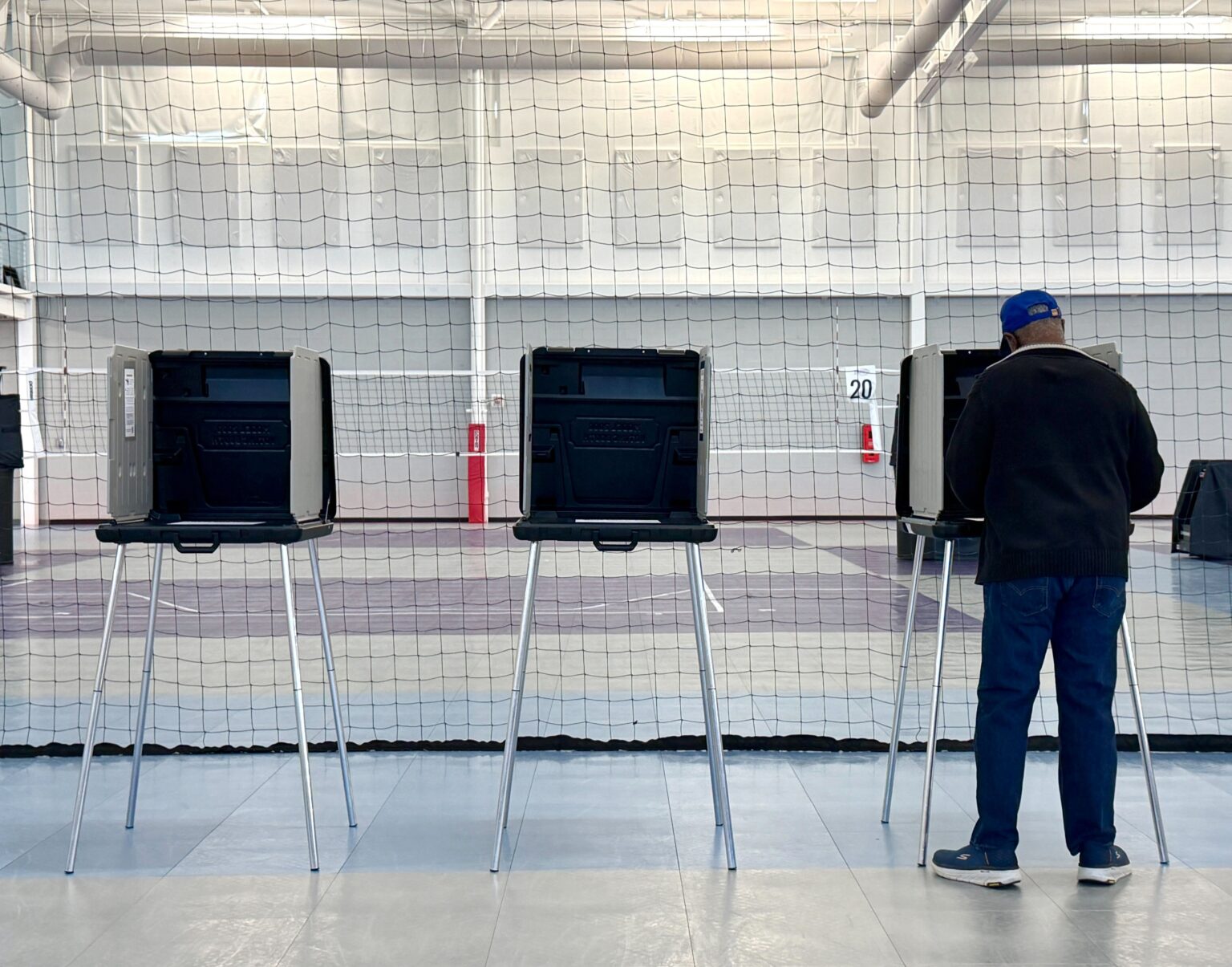 Voters standing in a long line outside a polling place in Richmond, Virginia during the April 2026 special election, news photography style