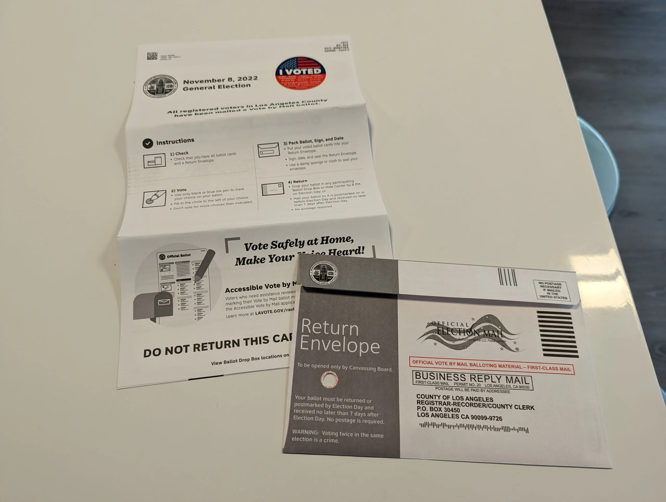 Voters waiting in line inside a Los Angeles County polling place in November 2022, with election workers checking in voters at tables, news photography style