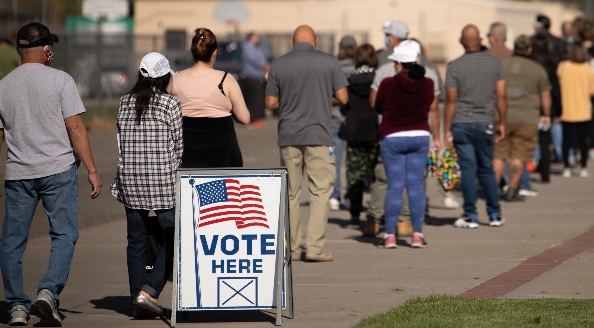 Voters waiting in line outside a local polling place on a November general election day, real editorial news photo