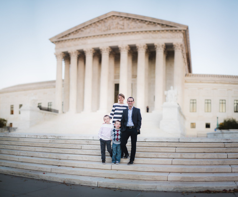 a family in front of the supreme court building