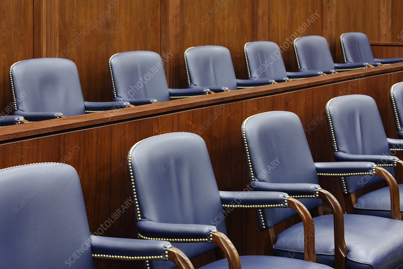 an empty jury box in a courtroom