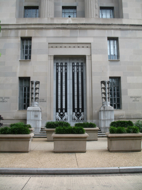 Department of Justice building entrance with motto