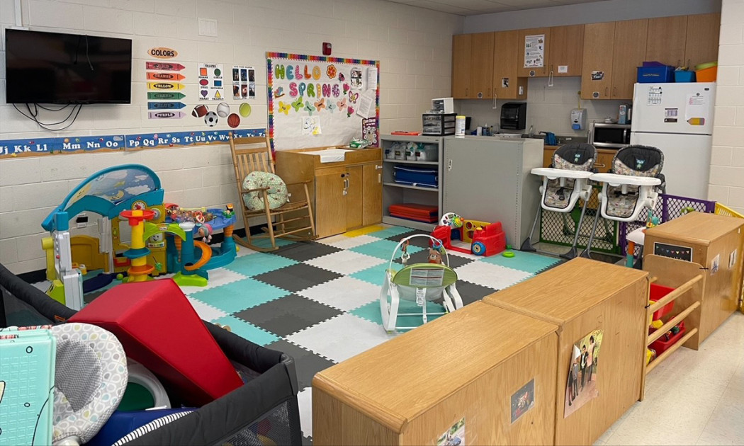 empty childcare classroom with small tables and chairs with fraud investigation documents