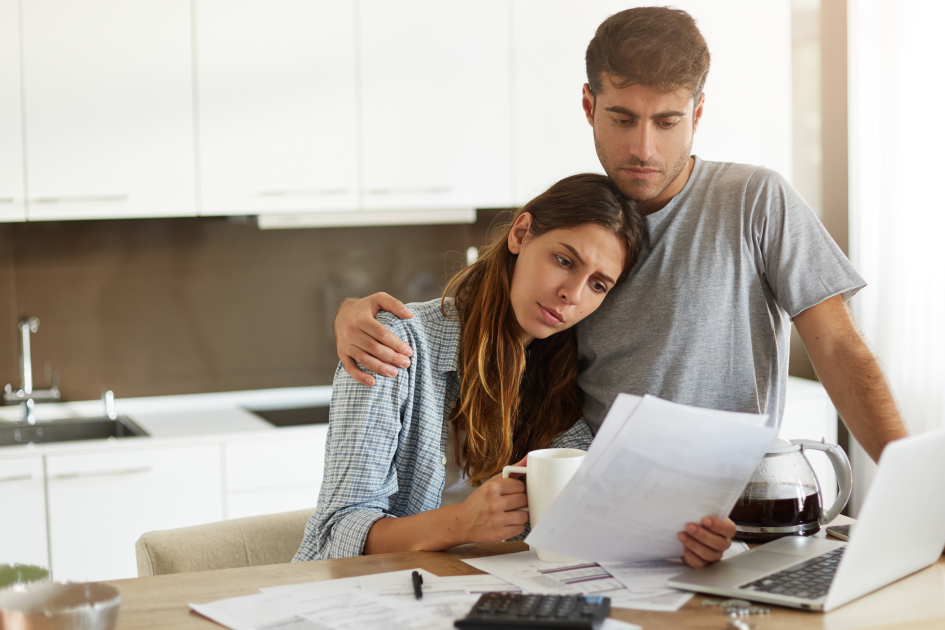 federal employee family reviewing bills at kitchen table