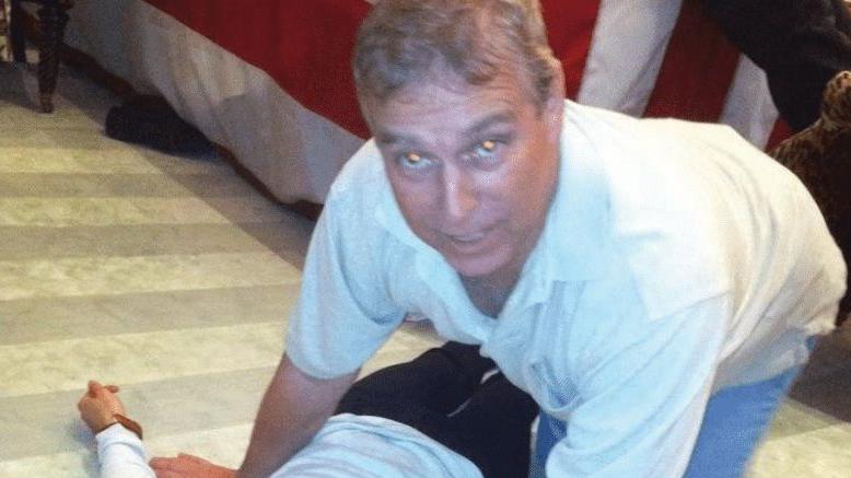 former prince andre photograph leaning over woman on floor