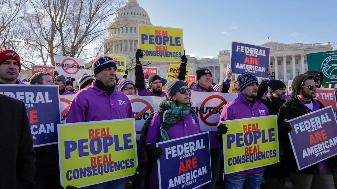 furloughed federal workers protesting with signs