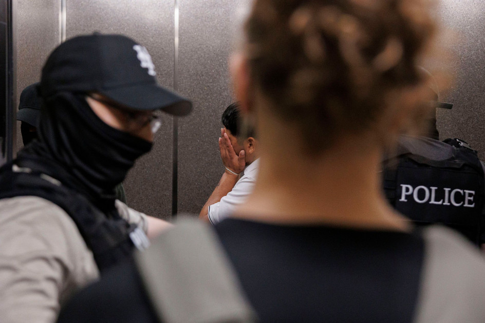 ICE agents standing outside a closed door