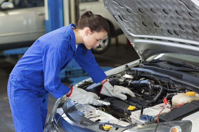 mechanic working on a car engine