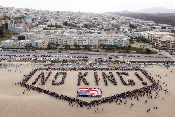 People form a human banner at Ocean Beach during the “No Kings” protests in San Francisco on Saturday, June 14, 2025. (Santiago Mejia/San Francisco Chronicle via AP)