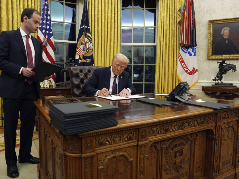 President Donald Trump signing an executive order in the Oval Office