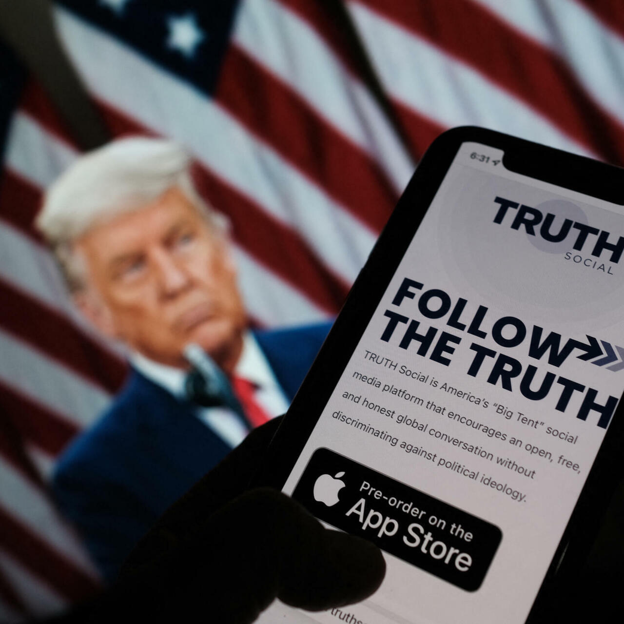 President Donald Trump using his phone to post on Truth Social