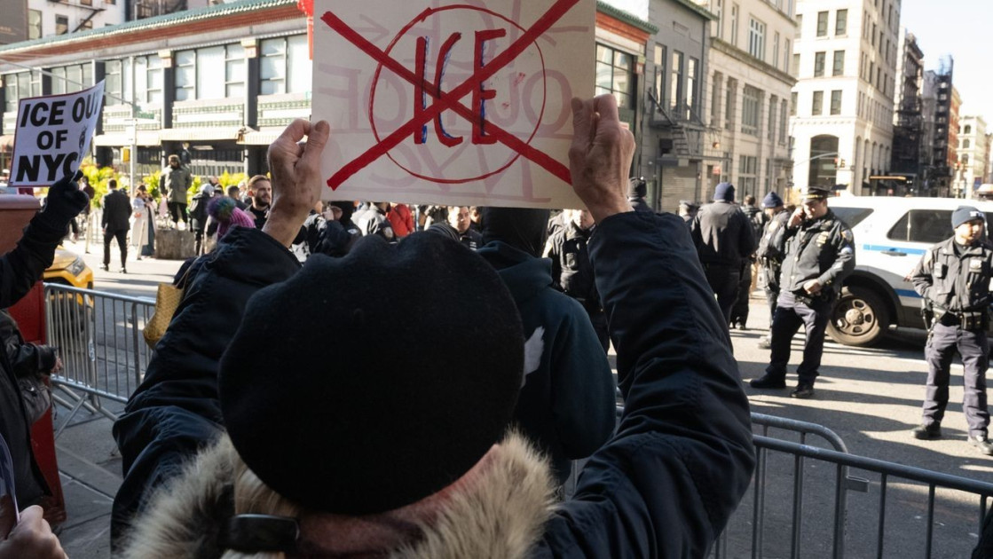 Protesters holding signs that read "Supremacy Clause" and "10th Amendment" facing off