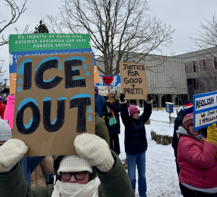 Protesters in Minneapolis holding signs for Alex Pretti