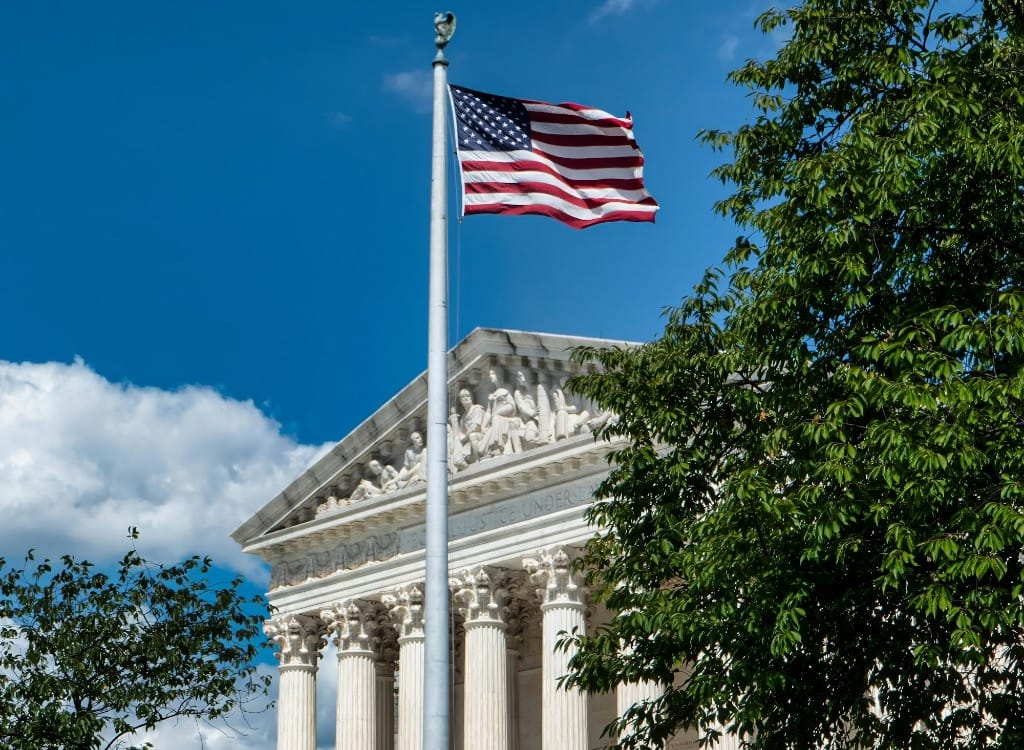 supreme court building with american flag