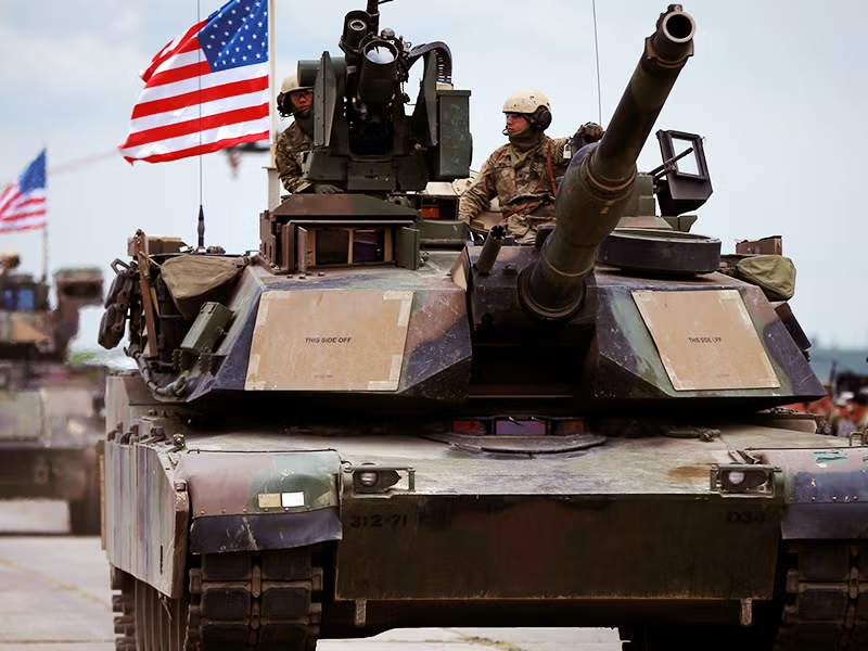 us tanks with american flags flying