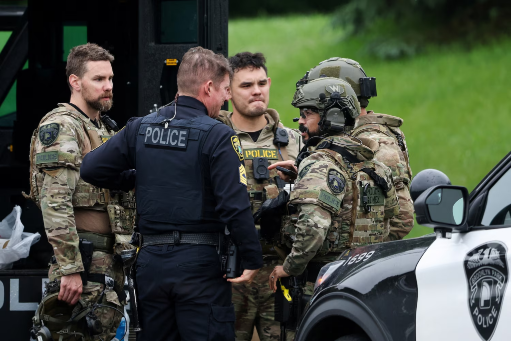 Officers communicate in a staging area after what police said was a targeted shooting in the area around Edinburgh Golf Course in the Minneapolis suburb of Brooklyn Park, Minnesota, June 14, 2025.
Ellen Schmidt/Reuters