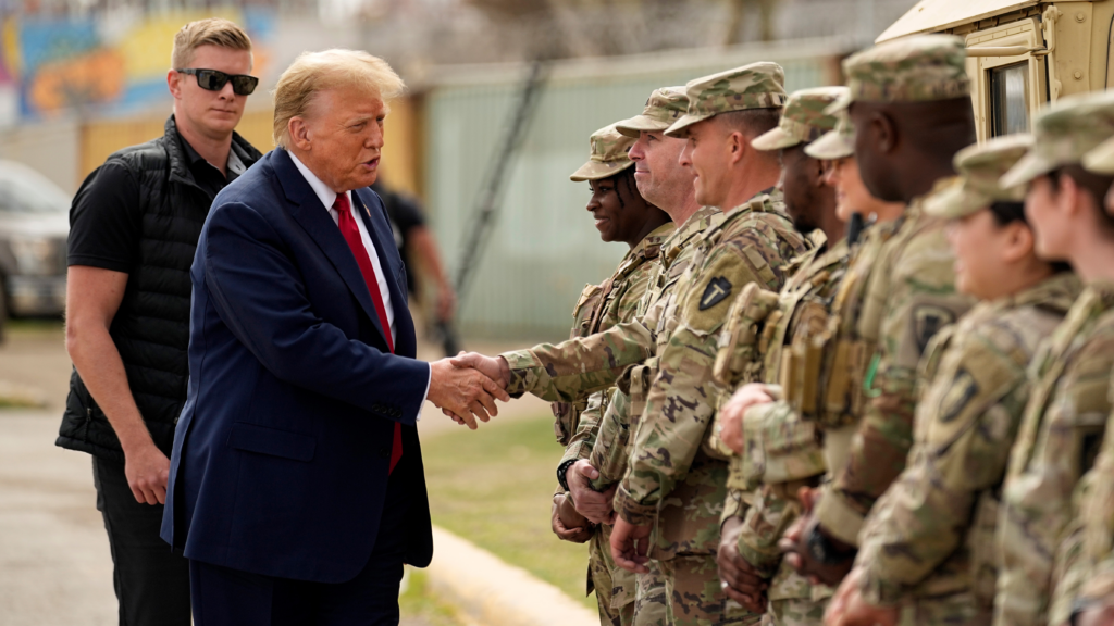 trump shaking hands with military troops